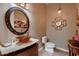 Stylish powder room features a vessel sink, decorative mirrors, and neutral color palette at 13117 W Micheltorena Dr, Sun City West, AZ 85375