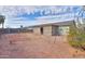 View of the backyard, featuring a covered patio, rock landscape, block wall, and blue sky at 1371 E Cactus Bloom Way, Casa Grande, AZ 85122