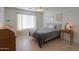 Cozy bedroom featuring tiled floor, ceiling fan, and a comfortable bed with gray blanket at 1371 E Cactus Bloom Way, Casa Grande, AZ 85122