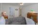 Bright bedroom with tiled floor, featuring desk, bedside table and doorways to bathroom at 1371 E Cactus Bloom Way, Casa Grande, AZ 85122