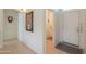 Neutral-toned entryway that opens to a hallway, laundry room and living spaces at 1371 E Cactus Bloom Way, Casa Grande, AZ 85122