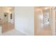 Neutral-toned hallway with tile flooring, leading to multiple rooms at 1371 E Cactus Bloom Way, Casa Grande, AZ 85122