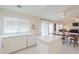 Open kitchen flows into dining area with a large island, white cabinets and natural light at 1371 E Cactus Bloom Way, Casa Grande, AZ 85122