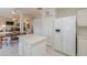 Spacious kitchen with island, white cabinets, tile floor, and a modern refrigerator at 1371 E Cactus Bloom Way, Casa Grande, AZ 85122