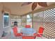 Covered patio with glass table and chairs, lattice privacy screen, grill, and ceiling fan at 1371 E Cactus Bloom Way, Casa Grande, AZ 85122