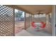 Covered outdoor patio features a glass table with chairs, lattice privacy screen, and a ceiling fan at 1371 E Cactus Bloom Way, Casa Grande, AZ 85122