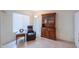 Cozy sitting room with tile floors, a comfortable chair, and a wooden hutch at 1371 E Cactus Bloom Way, Casa Grande, AZ 85122