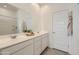 Bright and airy bathroom with a large mirror, dual sinks, and plenty of storage space at 15579 W Williams St, Goodyear, AZ 85338