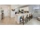 Bright kitchen featuring a quartz countertop island with seating, and sleek white cabinetry at 15579 W Williams St, Goodyear, AZ 85338