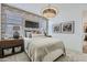 Cozy bedroom featuring an accent brick wall, neutral tones, and modern decor at 15751 W Pioneer St, Goodyear, AZ 85338