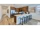 Modern kitchen with stainless steel appliances, white countertop and barstool seating at 15751 W Pioneer St, Goodyear, AZ 85338