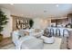 Open-concept living room with modern furnishings flowing into the dining area and kitchen at 15751 W Pioneer St, Goodyear, AZ 85338