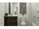 Well-lit bathroom with a modern vanity, toilet, and shower with stylish curtain at 15757 W Pioneer St, Goodyear, AZ 85338