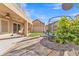 Landscaped backyard featuring a covered patio, artificial grass, and a trampoline at 16029 N 171St Dr, Surprise, AZ 85388