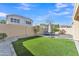 Backyard featuring lush landscaping, an artificial lawn, hardscape and trampoline at 16029 N 171St Dr, Surprise, AZ 85388