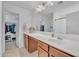 A vanity with cabinets, a white countertop, and a large mirror provide ample space and style at 16029 N 171St Dr, Surprise, AZ 85388