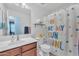 Bright bathroom featuring a white vanity, and a sunshine-themed shower curtain at 16029 N 171St Dr, Surprise, AZ 85388