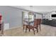 Dining area with a wooden table set, stylish light fixture, and a view of the backyard and living area at 16029 N 171St Dr, Surprise, AZ 85388