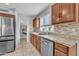 Kitchen sink with stainless steel appliances and tile backsplash at 16029 N 171St Dr, Surprise, AZ 85388