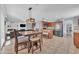 Open-concept kitchen and dining area with stainless steel appliances and tile flooring at 16029 N 171St Dr, Surprise, AZ 85388