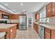 Kitchen featuring stainless appliances, wood cabinetry and granite countertops at 16029 N 171St Dr, Surprise, AZ 85388