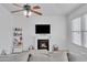 Warm living room featuring a cozy fireplace and mantle with a flat screen television at 16029 N 171St Dr, Surprise, AZ 85388