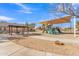 Community playground featuring sun shades, a picnic area, and modern play equipment for active recreation at 16029 N 171St Dr, Surprise, AZ 85388