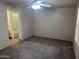 Carpeted bedroom with ensuite bathroom featuring a ceiling fan, neutral tones, and natural light at 16657 E Gunsight Dr # 296, Fountain Hills, AZ 85268