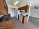 Traditional kitchen features tile flooring, brown cabinetry and a full sized white fridge and stove at 16657 E Gunsight Dr # 296, Fountain Hills, AZ 85268