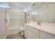 Well-lit bathroom showcasing a shower-tub combo and stylish vanity with ample storage at 16681 W Charlotte Dr, Surprise, AZ 85387