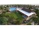 Aerial view of a clubhouse with a large covered patio, bocce ball court, pool and splashpad at 16681 W Charlotte Dr, Surprise, AZ 85387