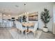 Bright dining area with wood table, stylish chairs, modern light fixture, and kitchen access at 16681 W Charlotte Dr, Surprise, AZ 85387