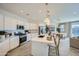 Modern kitchen featuring stainless steel appliances, island with sink, and adjacent dining area at 16681 W Charlotte Dr, Surprise, AZ 85387