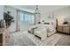 Tranquil bedroom with large window, a decorative light fixture, and stylish furnishings at 16681 W Charlotte Dr, Surprise, AZ 85387