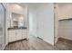 Bright bathroom showcases a glass shower, wood-look tile, granite counters, and a closet at 16765 W Bronco Trl, Surprise, AZ 85387