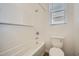 Bright bathroom featuring a shower-tub combo with white subway tile and a window for natural light at 16765 W Bronco Trl, Surprise, AZ 85387