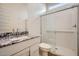 Bathroom featuring a granite vanity, shower, and natural light at 16765 W Bronco Trl, Surprise, AZ 85387