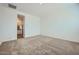 Bedroom featuring neutral carpet and a doorway into an ensuite bathroom at 16765 W Bronco Trl, Surprise, AZ 85387