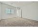 Neutral bedroom with plush carpet, window with blinds, and a walk-in closet at 16765 W Bronco Trl, Surprise, AZ 85387