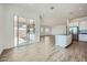 Open concept kitchen with island, white cabinets, and sliding glass doors to the patio at 16765 W Bronco Trl, Surprise, AZ 85387