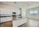 Well-lit kitchen with granite countertops, white cabinets, and stainless steel appliances at 16765 W Bronco Trl, Surprise, AZ 85387