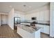 Modern kitchen featuring white cabinets, stainless steel appliances, and granite countertops at 16765 W Bronco Trl, Surprise, AZ 85387