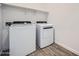 Well-lit laundry room featuring side-by-side washer and dryer at 16765 W Bronco Trl, Surprise, AZ 85387