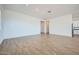 Spacious living room with wood-look tile flooring leading to other rooms in the home at 16765 W Bronco Trl, Surprise, AZ 85387