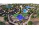 Aerial view of the community clubhouse and recreational area with parking, pool, and playground areas at 16781 W Bronco Trl, Surprise, AZ 85387