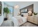 Stylish bedroom with a decorative wall accent, contemporary light fixtures, and neutral tones at 16781 W Bronco Trl, Surprise, AZ 85387