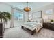 Inviting primary bedroom with a decorative light fixture, neutral tones, and a cozy bench at 16781 W Bronco Trl, Surprise, AZ 85387