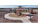 Playground featuring slides and shade structures in a community park with walking paths at 17550 W Victory St, Goodyear, AZ 85338