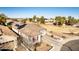 Aerial view of a home with solar panels, a two-car garage, a well-maintained lawn, and a charming picket fence at 17704 W Tasha Dr, Surprise, AZ 85388