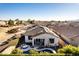 Aerial view of a home with a private pool, solar panels, and landscaped backyard in a peaceful neighborhood at 17704 W Tasha Dr, Surprise, AZ 85388